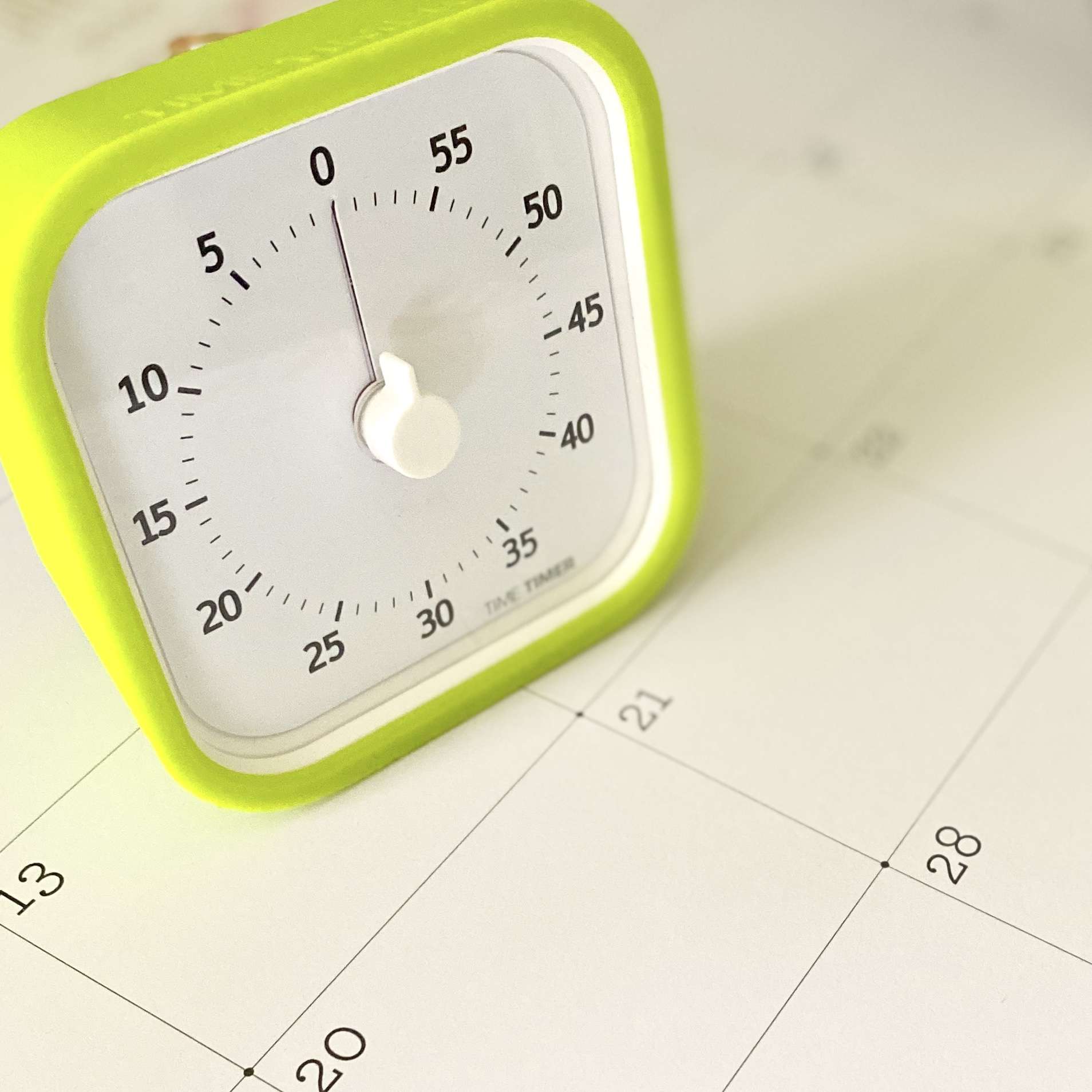 Time timer sitting on a desk top calendar